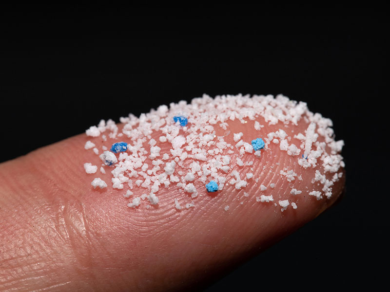 Small Plastic pellets on the finger.Micro plastic